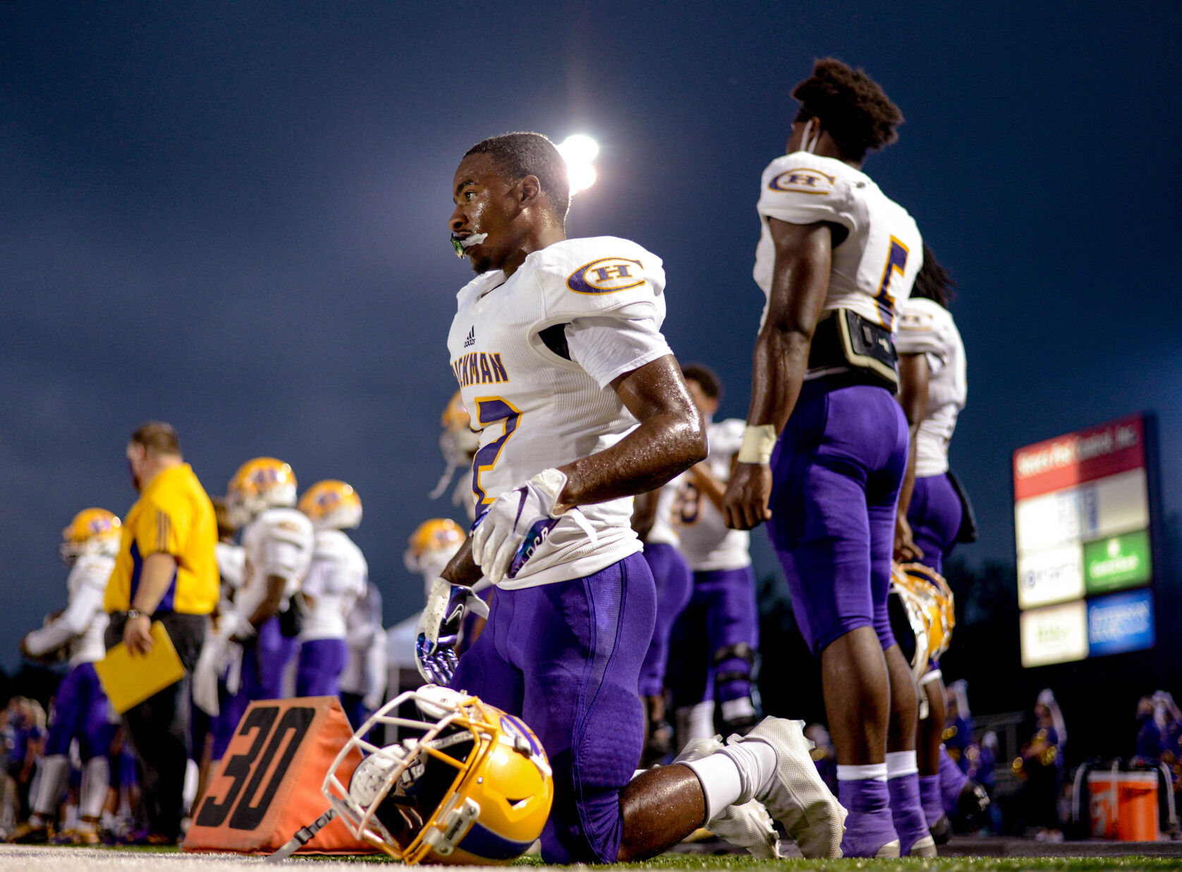 Hickman Wide Receiver LJ Williams get down to tie his cleats